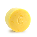 Citrus Shine conditioner bar for curly hair scented with orange bergamot and litsea cubeba essential oils contains calendula chamomile and turmeric all natural colour